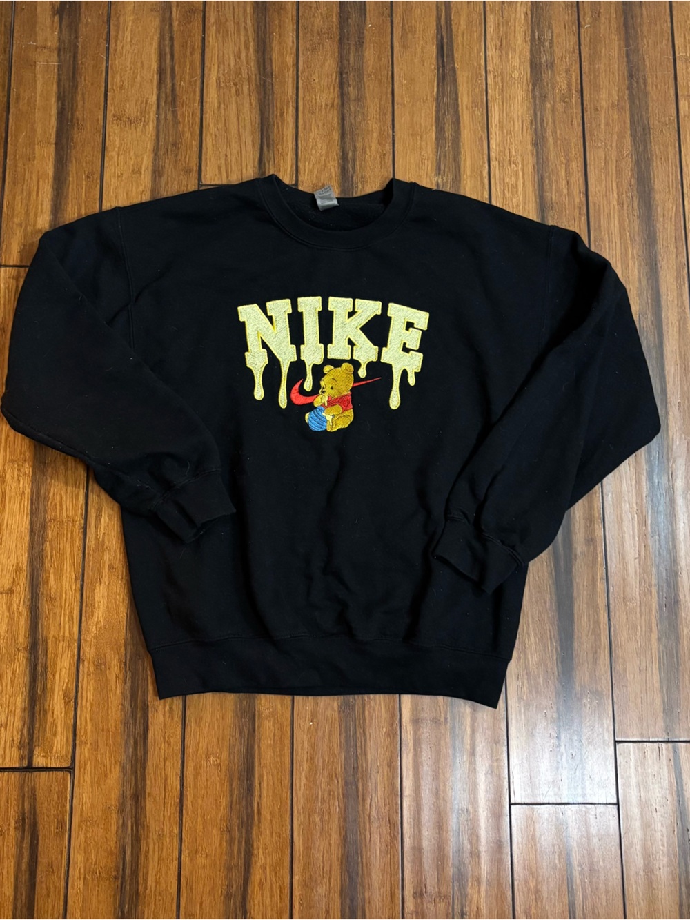 black crewneck with nike logo & winnie the pooh